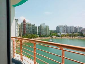 a balcony with a view of a river and buildings at PD Lagoon Resort in Port Dickson