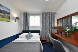 Ένα ή περισσότερα κρεβάτια σε δωμάτιο στο Hotel AGAT