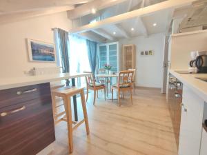 a kitchen and dining room with a table and chairs at Haus Paradies Superior FEWO`S Loft, Terrasse, private Sauna, aktiv Card, Sankt Englmar in Sankt Englmar