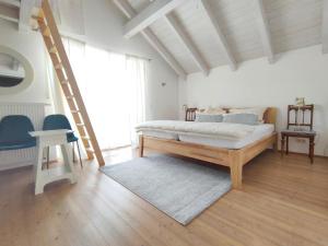 a bedroom with a bed in a room with a ladder at Haus Paradies Superior FEWO`S Loft, Terrasse, private Sauna, aktiv Card, Sankt Englmar in Sankt Englmar