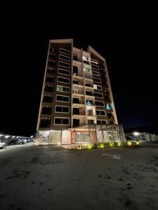 a tall building at night next to a beach at myRumah Imperio Home , Alor Setar 3BR with Sky Infinity Pool in Alor Setar
