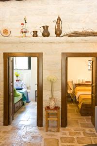 a living room with two mirrors and a bed at Trullo La Canonica in Martina Franca
