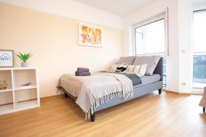 a bedroom with a bed with a dog on a blanket at FullHouse - Dessau - K36 Classic - Balcony in Dessau