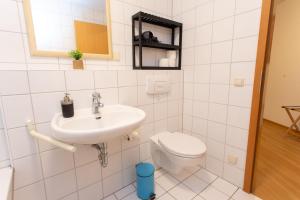a white bathroom with a toilet and a sink at FullHouse - Dessau - K36 Classic - Balcony in Dessau