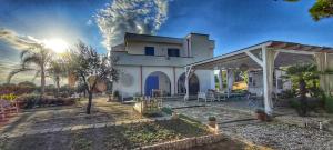 a large white house with a patio in front of it at B&B Sogno Salentino in Lizzano