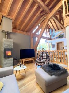a living room with a couch and a fireplace at Chez La Nanie in Saint-Paul-en-Chablais