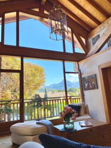 a living room with a large window with a view at Chez La Nanie in Saint-Paul-en-Chablais