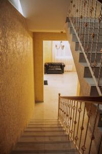 a staircase in a house with a yellow wall at Магия КМВ in Kislovodsk