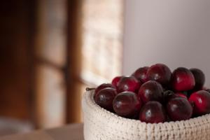 a bowl of red grapes sitting on a table at Antico Granaione in Rapolano Terme