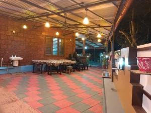 a room with a table and chairs in a building at Beach Nest in Kannur