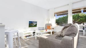 a living room with a couch and a table and a desk at 1 I-58 - Calella de Palafrugell in Calella de Palafrugell