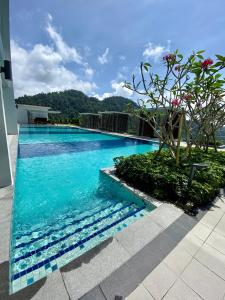 a swimming pool with blue water in a building at 2 Bedroom Apartment (Windmill Upon Hills, Genting Highlands) in Genting Highlands
