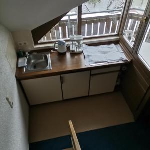 a small kitchen with a sink and a window at Ferienwohnungen Kupferkanne in Todtmoos +72 photos