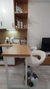 a kitchen with a wooden table and a white chair at Borovets Cozy Mountain Apartments in Borovets