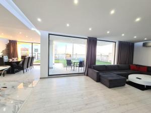 a living room with a couch and a table at Villa ARUBA in Balchik