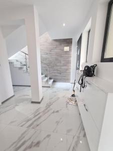a white hallway with a marble floor and stairs at Villa ARUBA in Balchik +25 photos