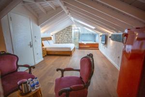 a bedroom with a bed and two chairs in a room at Kokopelli Alacati in Alaçatı +54 photos