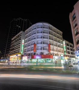 a building at night with a street in front of it at Victoria Hotel in Dubai