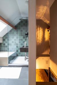 a bathroom with a sink and a glass shower at Lovely triplex in the heart of Le Sablon in Brussels