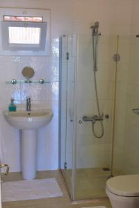 a bathroom with a shower and a sink and a toilet at Manzara Apartment in Kas +9 photos