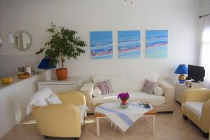 a living room with couches and chairs and a table at Manzara Apartment in Kas