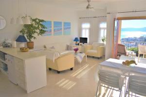 a living room with a couch and chairs and a table at Manzara Apartment in Kaş
