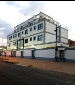 a large white building on the side of a street at Garden Top Hotel in Johannesburg