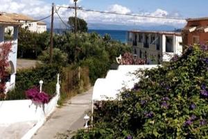 a view of a street with flowers and houses at Golden Keys Apatment first floor in Moraitika