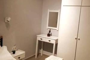a bathroom with a white sink and a mirror at Golden Keys Apatment first floor in Moraitika