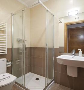 a bathroom with a shower and a toilet and a sink at Esnatuz - Basque Stay in San Sebastián