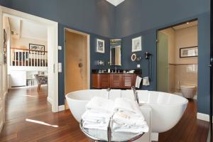 a large bathroom with a tub and a sink at Hotel Kaiserhof Wien in Vienna