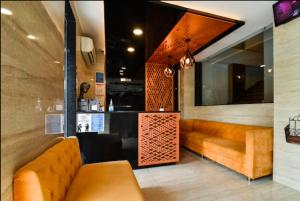 a lobby with a couch and a counter in a restaurant at Ka10 SQUARE HOTEL & BANQUETS in Jaipur