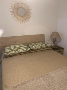 een slaapkamer met een bed met een spiegel aan de muur bij Home la Brezza in Santa Teresa Gallura