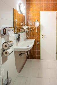 a bathroom with a sink and a mirror at Turmhof Breitenbrunn in Breitenbrunn