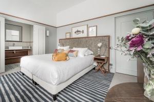 Un dormitorio con una cama con una bolsa amarilla. en Villa Arthus-Bertrand, en Noirmoutier-en-l'Île