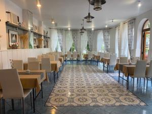 a restaurant with tables and chairs in a room at Willa Portowa - 120 metrów od plaży in Dziwnów