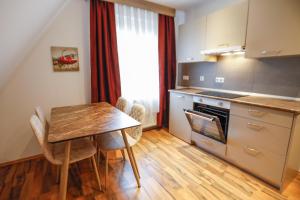 a kitchen with a wooden table and a table and chairs at Turis Ferienwohnung 65-3 in Triberg