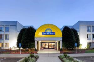a building with a day inn sign in front of it at Days Inn by Wyndham Newport News City Center Oyster Point in Newport News