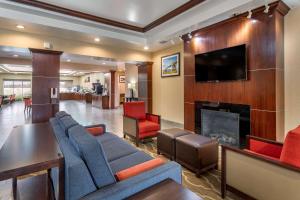a living room with a couch and a fireplace at Comfort Suites Olive Branch - Memphis South in Olive Branch