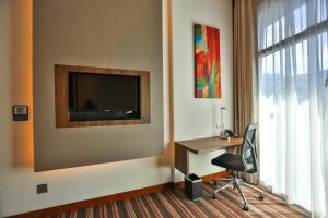 a room with a chair and a painting on the wall at Holiday Inn Express Singapore Clarke Quay, an IHG Hotel in Singapore