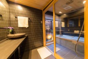a bathroom with a sink and a bath tub at Miro Hachijo Genmachi Tei in Kyoto +15 photos