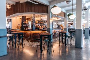 a bar in a restaurant with stools at Hotel Murcia Rincón de Pepe Affiliated by Meliá in Murcia