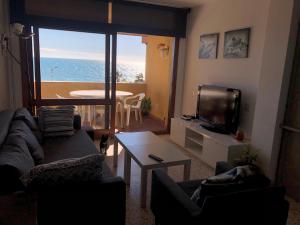 a living room with a view of the ocean at Bellamar in Torre de Benagalbón