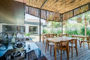 a dining room with a table and chairs at The Wave in Canggu