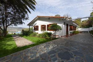 een klein wit huis met een patio en gras bij La Palmera - Santa Brígida, 3 dormitorios in Santa Brígida
