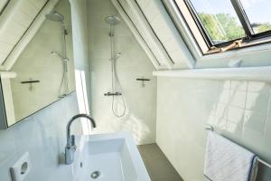 a bathroom with a shower and a sink and a window at de Buwepleats in Drogeham +61 photos