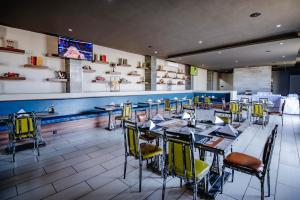 a restaurant with tables and chairs and a bar at Urban Bliss Hotel in Kabwe