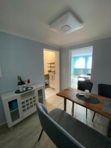 a living room with a table and a dining room at Ferienwohnung Familie Seuferle in Schweigen-Rechtenbach