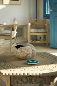 a wooden table with a basket on top of it at Villa Mikros Vorias in Karavostasi