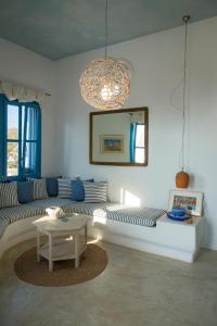 a living room with a couch and a table at Villa Mikros Vorias in Karavostasi +71 photos